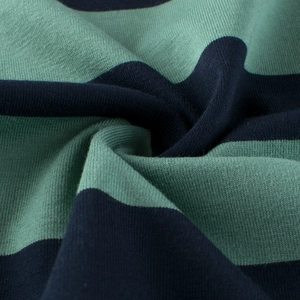 Detailed close-up of soft navy blue and sage green striped cotton jersey knit fabric