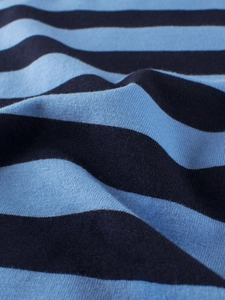Close-up of soft blue and white striped cotton fabric for kids summer short sleeve t-shirts