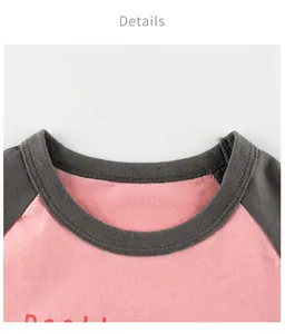 Detailed close-up of pink and grey contrast raglan neckline on cotton kids T-shirt