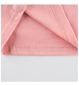 Close-up of pink cotton T-shirt hem featuring high-quality double-needle stitching detail