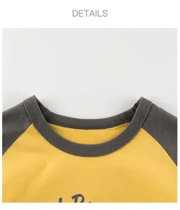 Detail view of the round neckline and double stitching on a kids cartoon raglan t-shirt