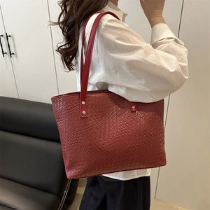 Large red woven tote bag for women with silver metal rings and spacious interior