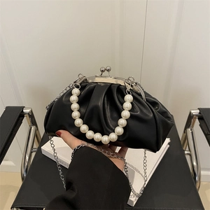 Black ruched cloud bag with pearl handle and silver chain strap for crossbody wear