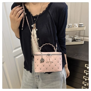 Pink quilted bag with diamond studs, metal rose pendant, and leather chain strap detail