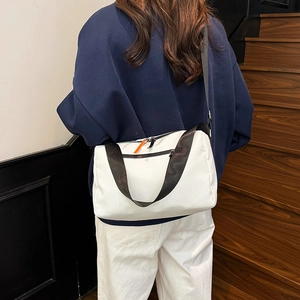 Waterproof white crossbody bag with wide black strap and orange zipper detail