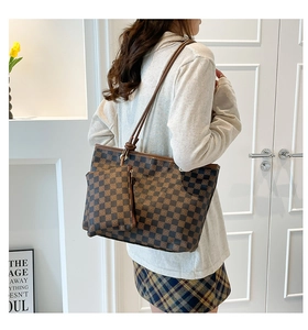 Detail of checkered tote bag and matching mini pouch with dual zipper in brown leather
