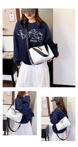 Détail d'un sac bandoulière blanc en nylon avec sangle réglable et tirette orange