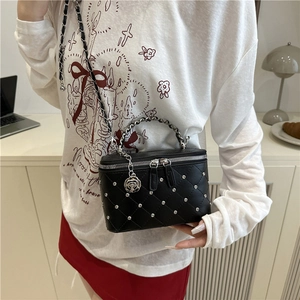 Black quilted box bag with silver studs and chain handle for casual crossbody wear