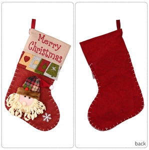 Detail of red felt Christmas stockings with 3D Santa and Merry Christmas embroidery