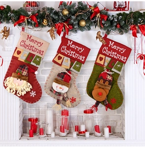 Detailed view of Christmas stockings featuring Santa, snowman and reindeer on a fireplace