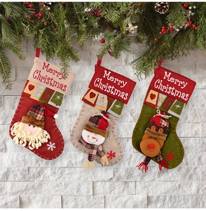 Detailed close-up of 3D Santa, Snowman, and Reindeer Christmas stockings with plaid scarves
