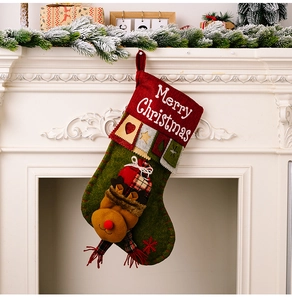 Close-up of a Christmas stocking with 3D reindeer decor hanging on a festive mantel