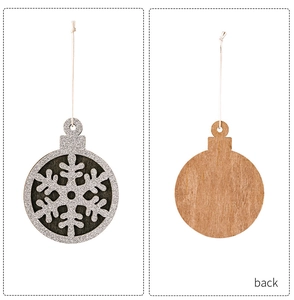 Detail of wooden Christmas ornament with glitter snowflake and natural wood back texture