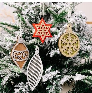 Detailed view of assorted wooden Christmas tree ornaments with glitter and snowflakes