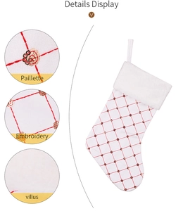 Detail showing white Christmas stocking with red embroidery and golden sequins