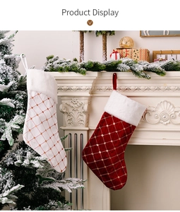 Quilted Christmas stockings with gold dots and plush trim hanging by a fireplace