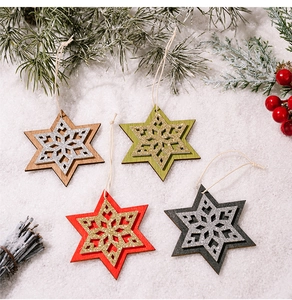 Close-up of set of 4 wooden star ornaments with glitter snowflakes for Christmas decor