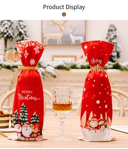 Detail of red Christmas wine bottle covers with festive illustrations and gold ribbons