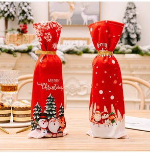 Detail of red Merry Christmas wine bottle bags with Santa and reindeer cartoon prints