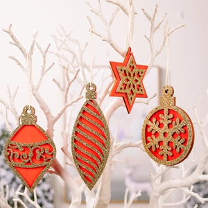 Set of 4 red and gold wooden Christmas ornaments hanging on white decorative branches
