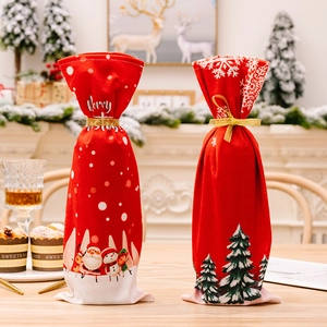 Christmas wine bottle covers with Santa and snowman prints on a rustic wooden table