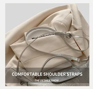 Detail of silver textured dumpling bag with adjustable shoulder strap and metal buckle
