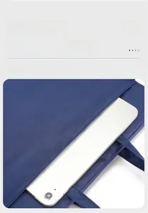 Detail of navy nylon laptop bag showing front pocket storage for a tablet device