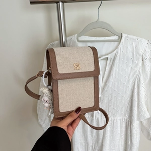 Chic canvas mini crossbody bag with leather trim and gold clover charm for summer