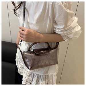 Close-up of the vintage bronze metallic bag with unique wrinkled texture and silver buckle