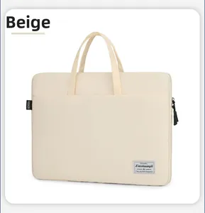 Detail view of the minimalist beige laptop bag featuring side zippers and woven branding