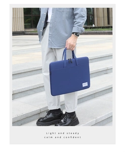 Blue nylon business laptop bag with reinforced handles shown against a modern staircase