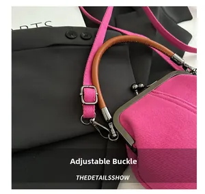 Detailed macro view of the adjustable metal buckle on a pink denim crossbody bag