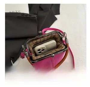 Internal view of pink canvas kiss-lock bag showing space for smartphone and wallet