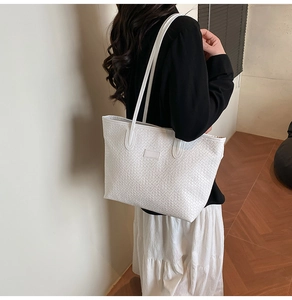Side view of white woven tote bag showing large capacity and textured surface