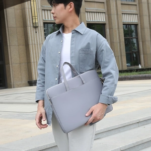 Sleek grey minimalist laptop messenger bag for business commuting and outdoor travel