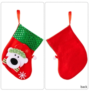 Detail of Christmas stocking decoration with sequin cuff and polar bear plush character