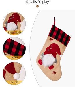 Detail of burlap Christmas stocking featuring gnome applique and red black plaid trim