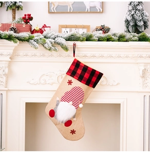Detail of Christmas stocking featuring 3D gnome decor and red-black buffalo plaid cuff