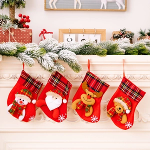 Set of 4 Christmas stockings with snowman and Santa hanging on a classic fireplace mantel