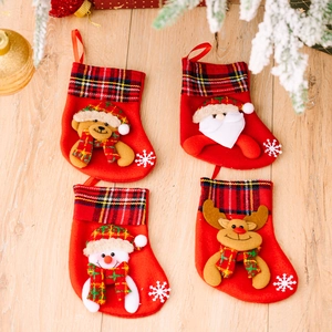 Set of 4 Christmas stockings with festive plaid cuffs and cute 3D cartoon characters