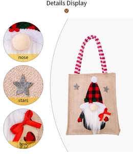 Detail display of Christmas gnome burlap bag featuring plush nose and red silk bow
