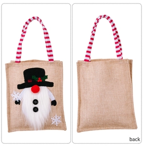 Detailed front and back views of linen Christmas gnome gift bag with striped handles
