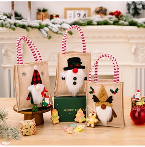 Detailed close-up of three Christmas burlap gift bags with 3D gnome applique and plaid hats