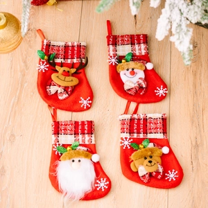 Set of 4 Christmas stockings with Santa, Reindeer, Snowman, and Bear on wood surface