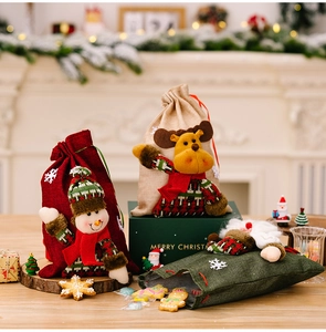 Detailed view of burlap Christmas gift bags with 3D plush Santa, Reindeer and Snowman icons