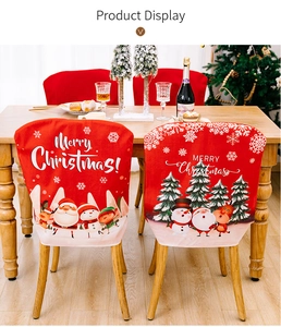 Detail of red Merry Christmas chair covers with Santa and reindeer in a dining room