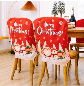 Close-up of red Merry Christmas chair covers with festive cartoons in a cozy dining room