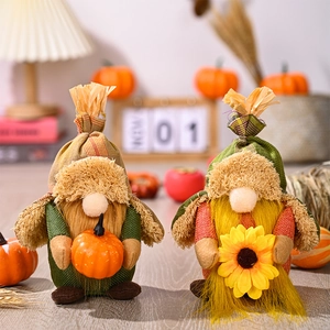 Detail of plush harvest gnomes holding pumpkins and sunflowers in a cozy autumn setting