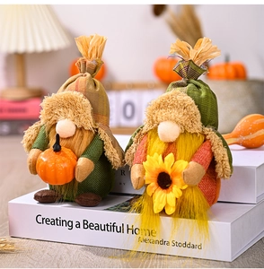 Close-up of autumn harvest gnomes with pumpkins and sunflowers on decorative books