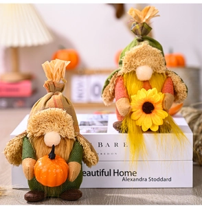Detailed close-up of autumn gnomes featuring a pumpkin and a bright yellow sunflower